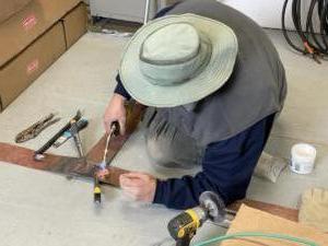 Rob solders the ground strap