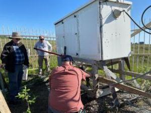 Stabilizing the tuning cabinet at the base of the East Tower.  Chris, Tom, & Nate